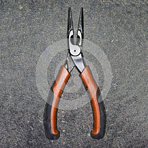 Gripper, Tool, Tool-Kit, Factory. Old pliers on grey stone background.
