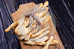 Grisini on wooden plate