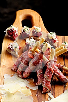 Grissini bread sticks with ham, Cheese, basil