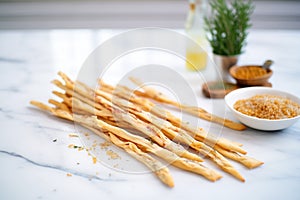 grissini breadsticks fanned out on a marble surface
