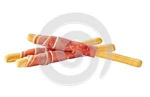 grissini or breadsticks with parma ham prosciutto isolated on white background. breadsticks with prosciutto isolated