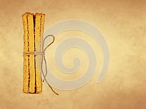 Grissini breadsticks with sesame seeds on old paper background