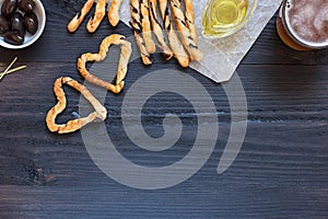 Grissini heart traditional italian snack, food composition on black wooden background