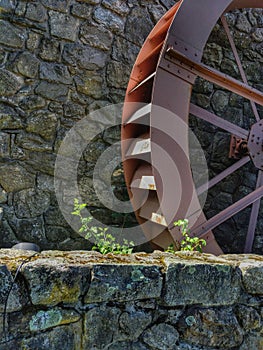 Gristmill Wheel on Stone Wall photo