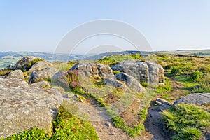 Gritstone, heather and footpaths on a hazy Baslow Edge