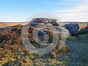 Gritstone rock formation on Curbar Edge on a frosty morning.