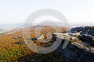 From the gritstone rocks of Surprise View over a misty Hathersage Moor on an autumn morning photo