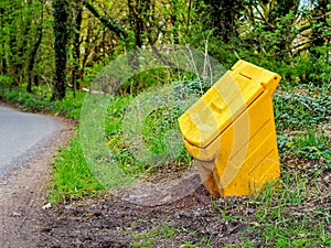 gritting bin by the road side yellow high visibility grit storage for slippy ice covered roads in winter photo