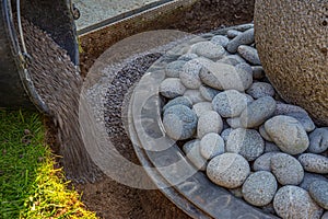 Gritting material filled into the curb of a garden fountain photo