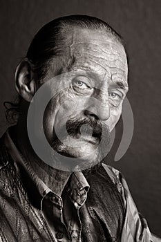 Gritty Looking Biker Man with Horseshoe Mustache and Black Leather Jacket