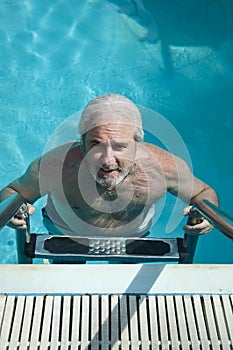 grizzled man in bermudas pool. summer vacation in bermudas. man swim in bermudas resort
