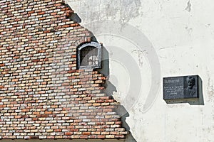 Grobina, Latvia - Juny 11, 2022: Artwork with a partial brick wall and a prison window with bars