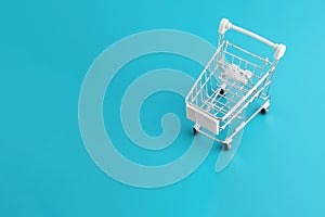 Grocery cart from the supermarket on a blue background