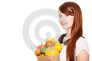 Grocery. Girl holding paper shopping bag with fruits
