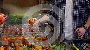 Grocery shopper buying exotic fruit