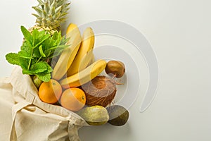 Grocery shopping with eco bag over white background. Zero waste and plastic free concept. Flat lay, top view. Copy space