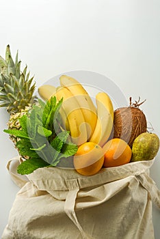 Grocery shopping with eco bag over white background. Zero waste and plastic free concept. Flat lay, top view. Copy space