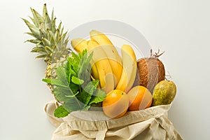 Grocery shopping with eco bag over white background. Zero waste and plastic free concept. Flat lay, top view. Copy space