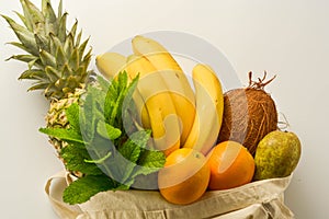 Grocery shopping with eco bag over white background. Zero waste and plastic free concept. Flat lay, top view. Copy space