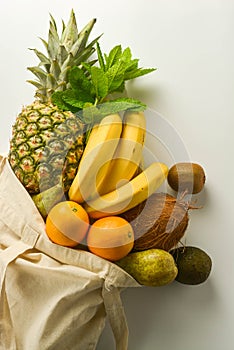 Grocery shopping with eco bag over white background. Zero waste and plastic free concept. Flat lay, top view. Copy space