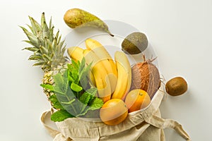 Grocery shopping with eco bag over white background. Zero waste and plastic free concept. Flat lay, top view. Copy space