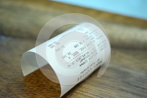 Grocery shopping roll printout on a wooden table