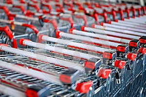 The grocery shopping trolleys stacked. Lots of empty carts in the supermarket