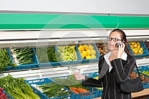 Grocery store - Business woman with mobile phone