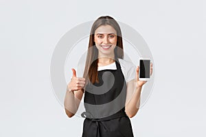 Grocery store employees, small business and coffee shops concept. Satisfied cute friendly-looking barista or waitress