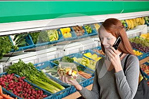 Grocery store - Red hair woman with mobile phone