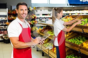 Grocery store staff with clipboard