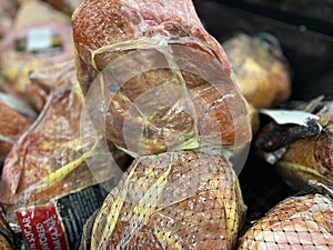 Grocery store whole hams on display