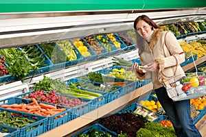 Grocery store - Woman holding spring onion