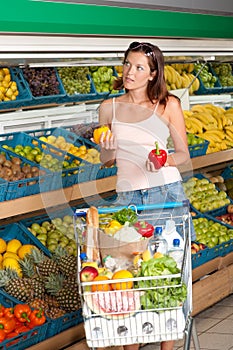 Grocery store - Young woman choosing pepper