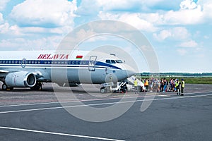 GRODNO, BELARUS - AUGUST 2019: crowd of tourists near the plane awaiting flight. Aircraft that await passengers