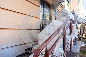 Grodno, Belarus, February 25, 2022: New arrival of clothes in a second-hand store. Old used clothes in large plastic bags.