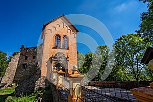 Grodno Castle surrounded by greenery under the sunlight and a blue sky in Zagorze, Poland