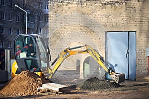 Grodno - November 2021: JCB 8018 CTS excavator digging sand and concrete at construction site. JCB mini excavator