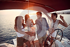 Groggy friends on a yacht enjoying the sunset photo