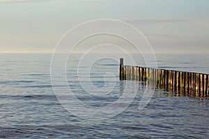 Groin at at the baltic sea beach of ustronie morskie, poland in the evening sun