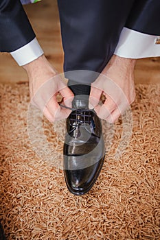 Groom black elegant shoes. Wedding detail. Close up