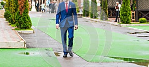 Groom in blue suit is on the green track at