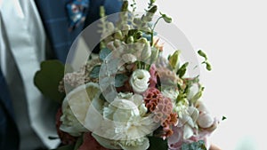 Groom with a bouquet of flowers