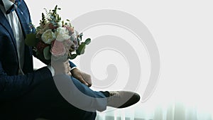 Groom with a bouquet of flowers