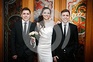 Groom with the bride and the brother of the groom of the twin