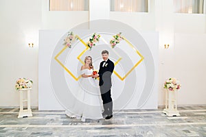 the groom and the bride with a candle in his hands at the wedding ceremony