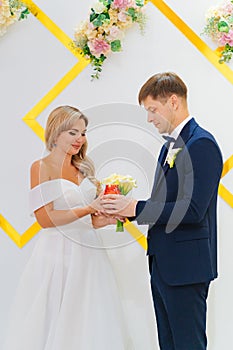 the groom and the bride with a candle in his hands at the wedding ceremony