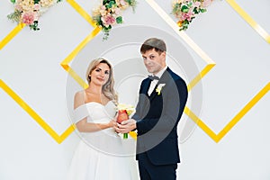 the groom and the bride with a candle in his hands at the wedding ceremony