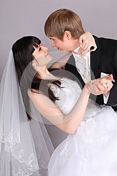 Groom and bride dance in studio