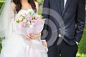 Groom and bride holding bouquet